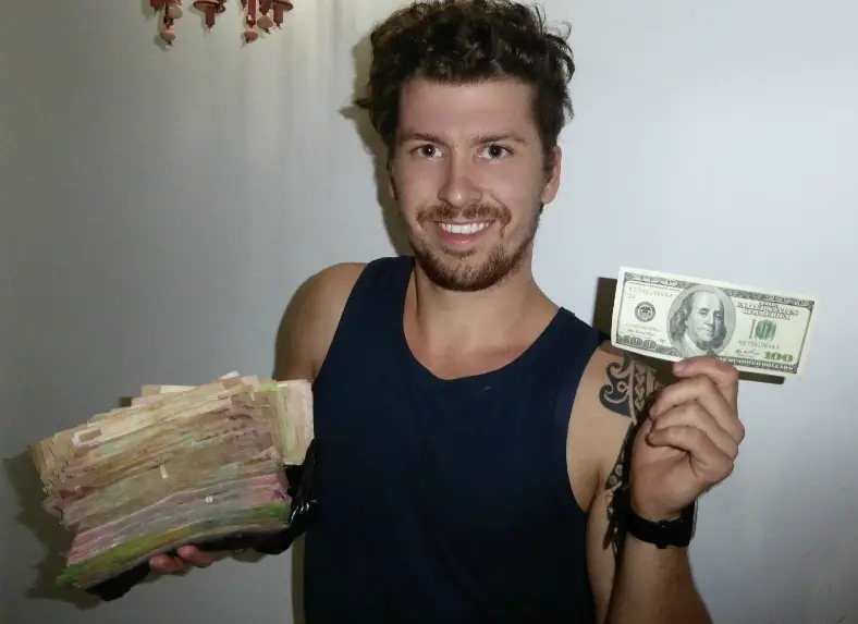will holding a stack of cash in venezuela