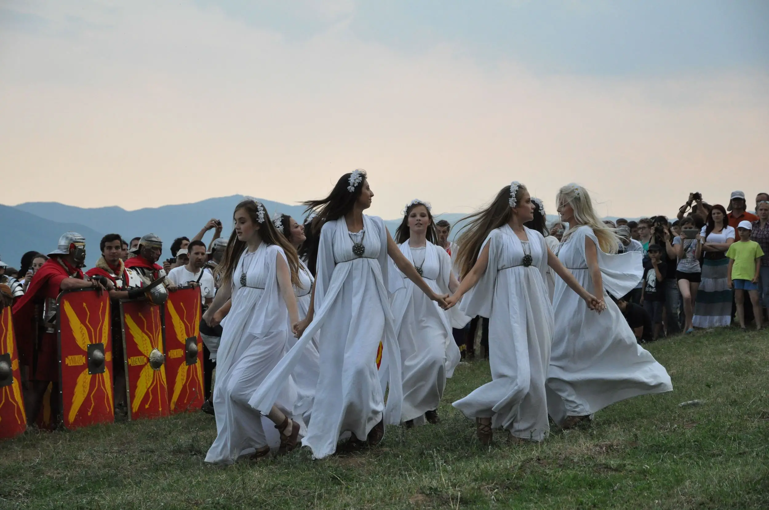girls in white dresses dancing in a circle