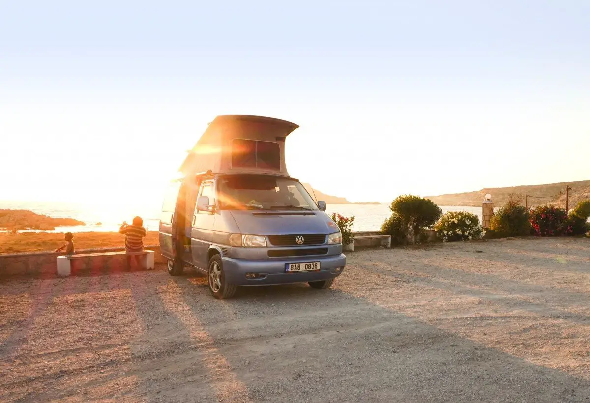 A hire campervan in Greece parked by a beach