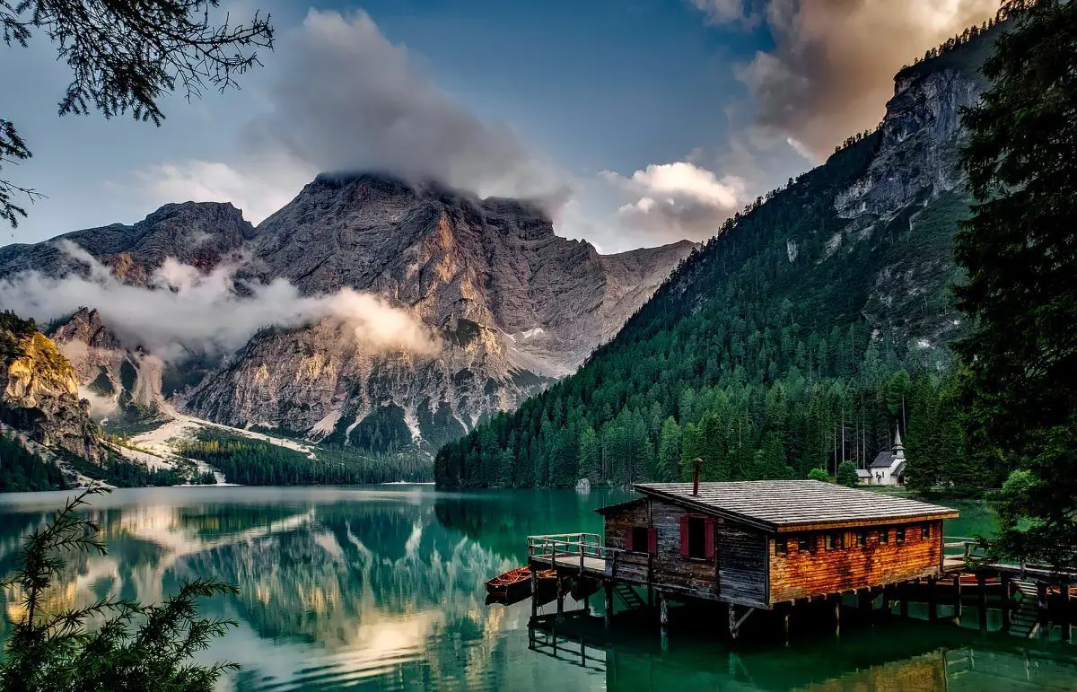 alpine lake and cabin in the dolomites of italy