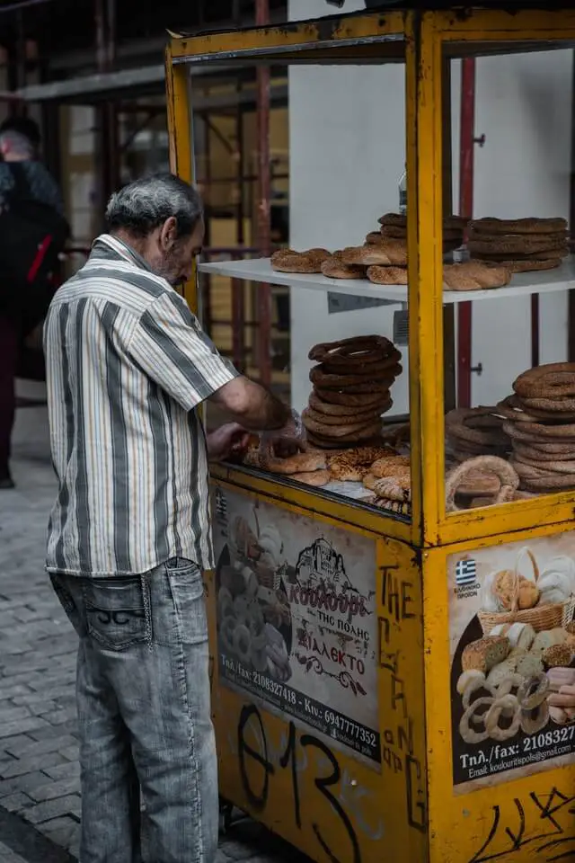 A street food merchanty in Athens serves out some local food to hungry backpackers in Greece