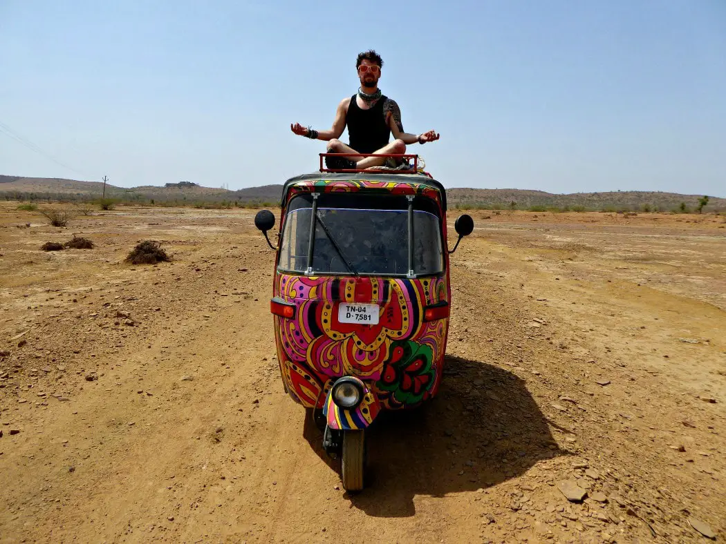 will on top of his rickshaw in india