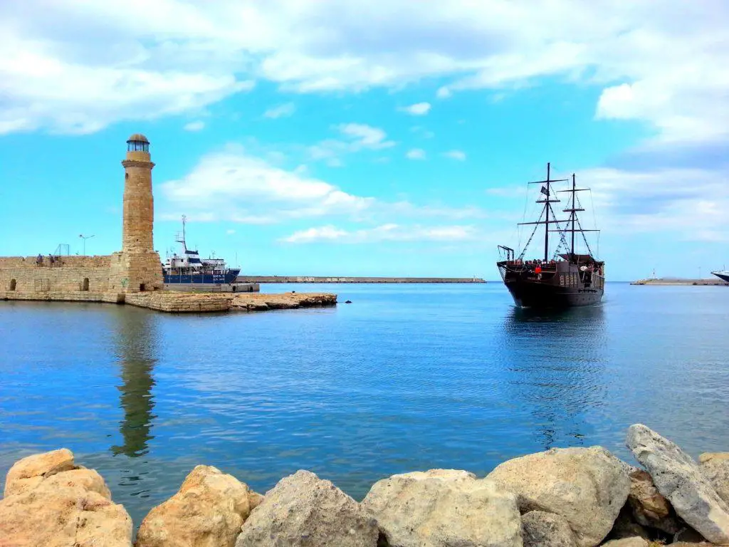 A lighthouse and ship at Rethymno - Popular tourist place in Crete