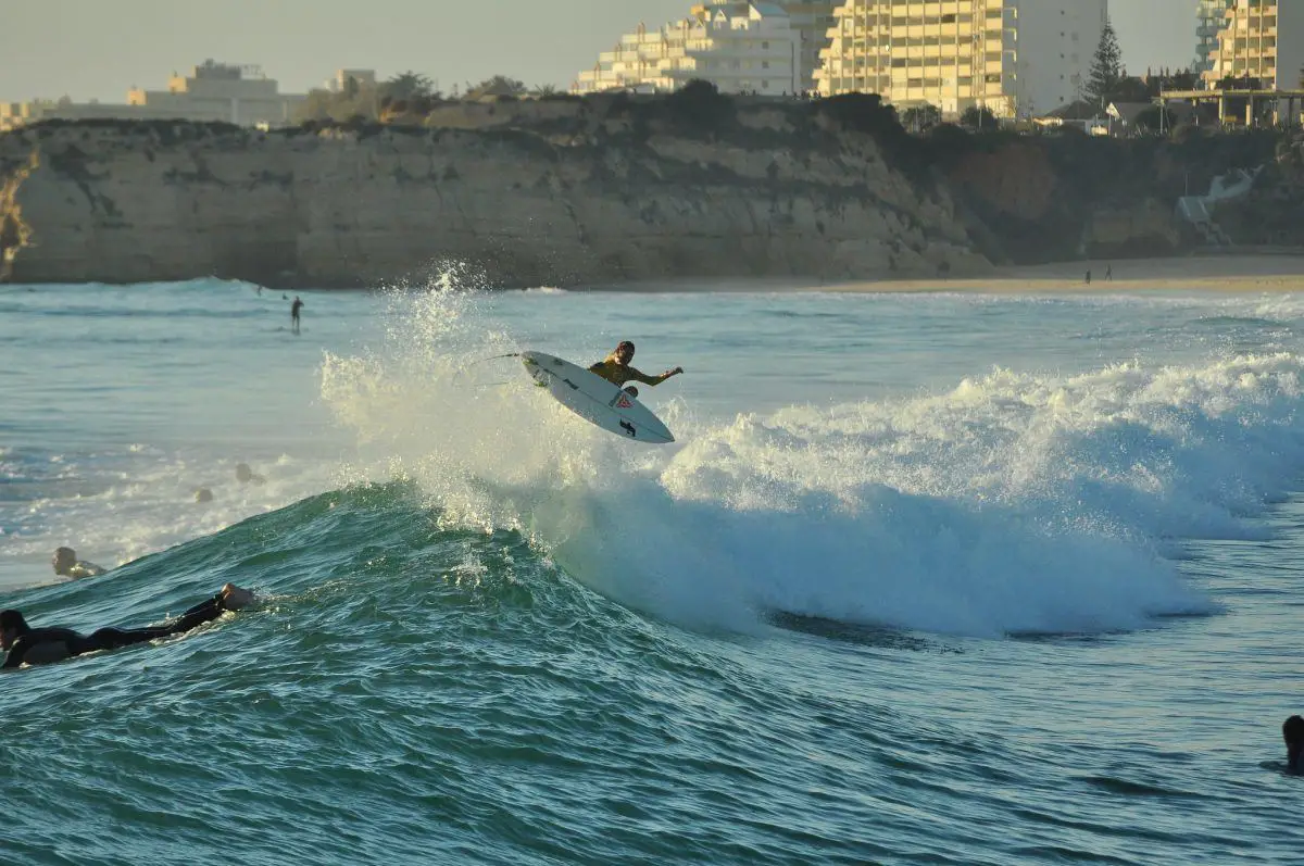 Surfer catching a awave in the algarve portugal