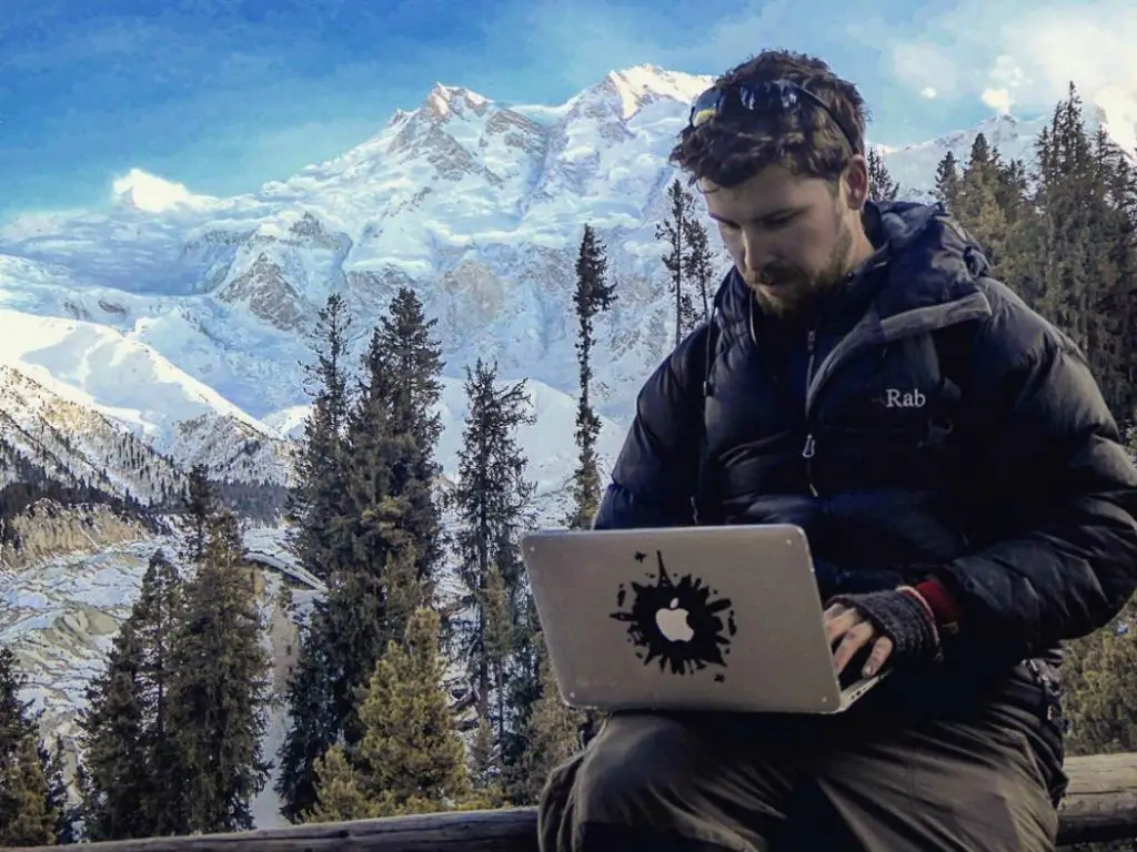 will hatton working on the laptop with mountain backdrop